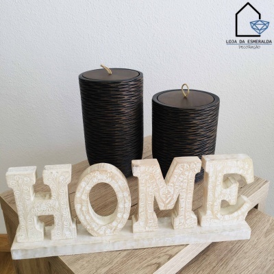 Decoração mãos com letras HOME creme com textura, velas pretas texturizadas, logótipo loja da esmeralda