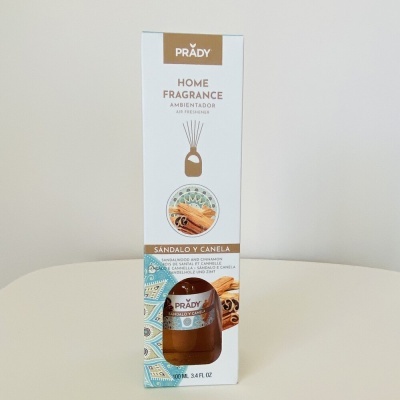 Embalagem branca de ambientador líquido Prady com imagens de canela e sândalo
