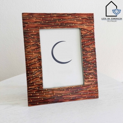 Moldura de fotografia em madeira escura com padrão de ramos e botões