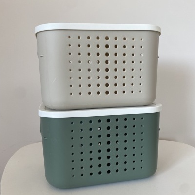 Caixas de arrumação cinzenta e verde com tampas brancas e furos circulares