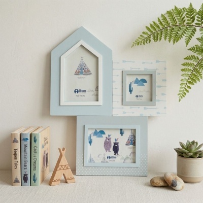 Conjunto de molduras de fotos azuis e brancas em forma de casa, livros infantis, tenda de madeira, planta e pedras sobre tecido bege