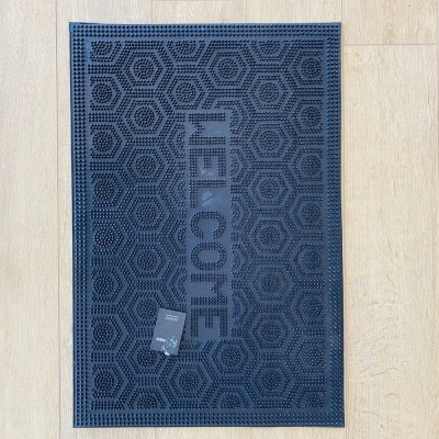 Tapete retangular azul escuro com a palavra WELCOME em relevo