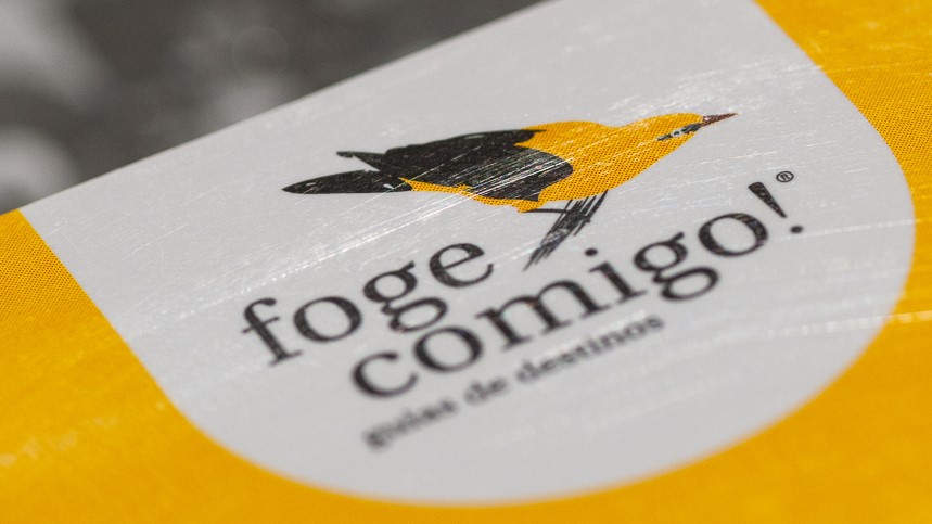 Etiqueta com pássaro amarelo e preto e texto 'foge comigo! guia de destinos'