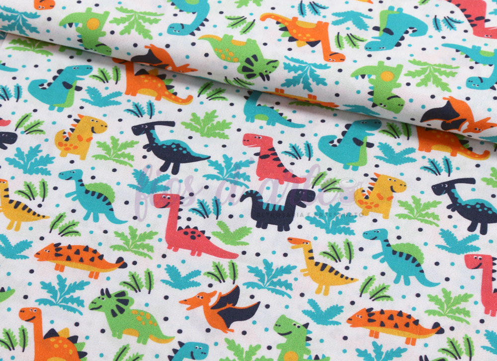 Tecido Pequenos Dinossauros Tecido branco com padrão colorido de dinossauros e folhas verdes