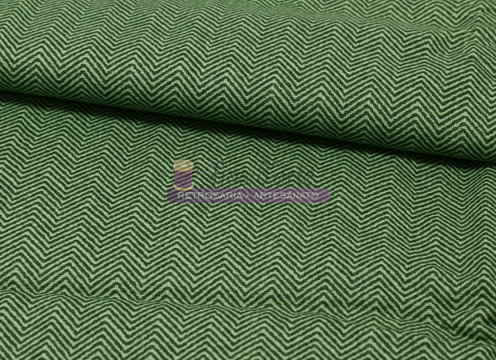 Tecido Efeito Tweed (Fabricart) - musgo Tecido verde com padrão zig-zag branco e etiqueta colorida com texto impresso