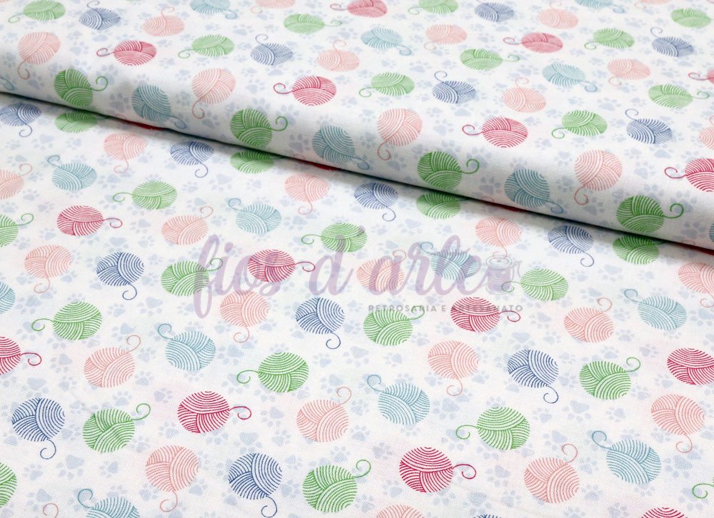 Tecido com padrão de novelos de lã coloridos sobre fundo branco