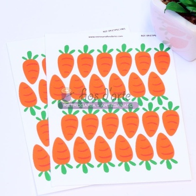 autocolantes com ilustrações de cenouras e texto sobre mesa branca ao lado de vaso com planta