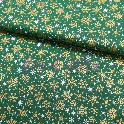 Tecido verde com flocos de neve dourados e brancos
