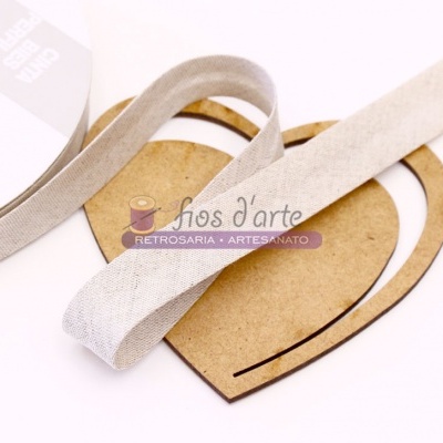 Fita de tecido bege macia sobre suporte de madeira em forma de coração