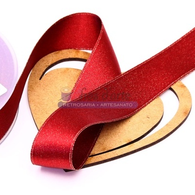 Fita de cetim vermelha enrolada num cartão castanho e carretel branco