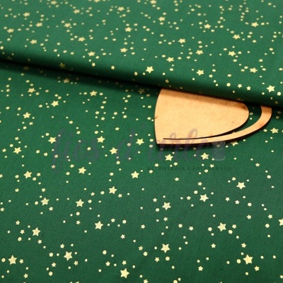 Tecido verde com estrelas douradas, rolo dobrado com etiqueta de papel