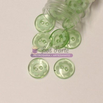 Botões de plástico verde translúcido com quatro furos e recipiente transparente
