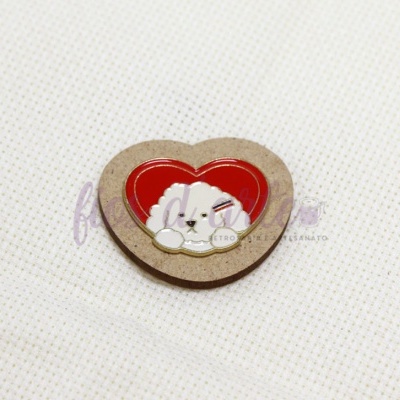 Botão coração de madeira com desenho de coelho e forma vermelha sobre tecido branco