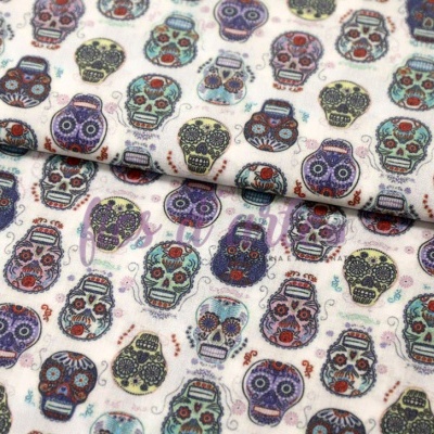 Tecido branco com padrão colorido de caveiras desenhadas
