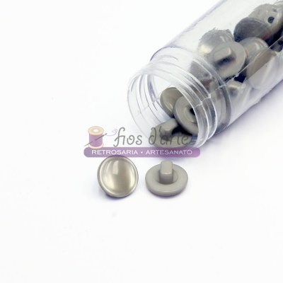 Tubo transparente com botões prateados de plástico