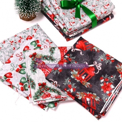 tecidos natalícios com estampas vermelhas, verdes, brancas e pretas, decorados com motivos festivos