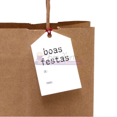 Etiqueta branca com texto 'boas festas' pendurada em saco de papel castanho