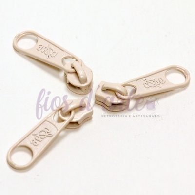 Puxadores de fecho éclair bege com palavra 'tigor' gravada