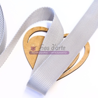 Fita cinza sobre forma de coração de madeira clara com texto jac's arte