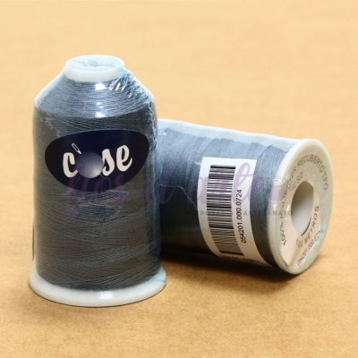 Dois carretéis de linha cinza sobre uma superfície bege