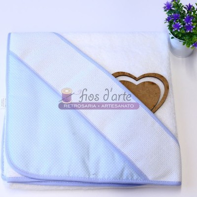 Toalha de banho branca com capuz azul claro e vaso com flores roxas