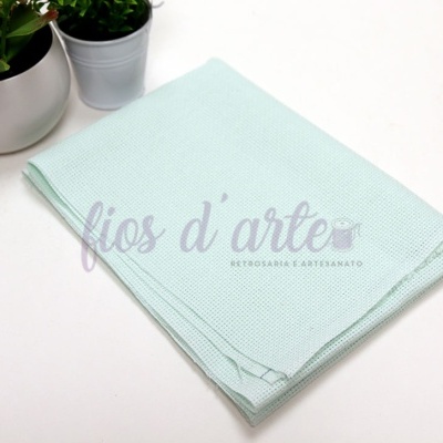 Guardanapo verde-água com pontos pequenos ao lado de vasos de plantas pequenas