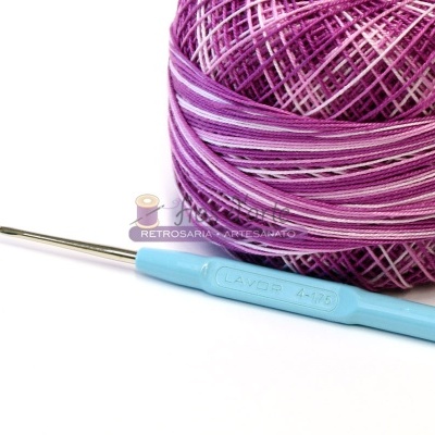 Agulha de crochê azul claro com novelo de linha roxa e lilás