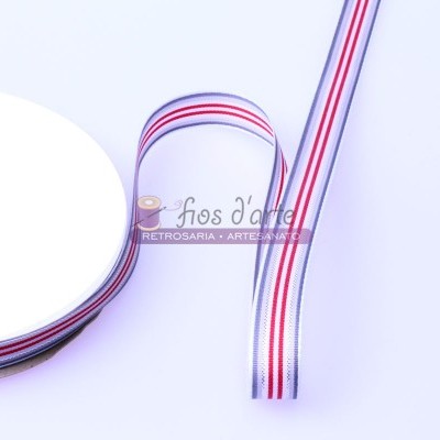 Fita decorativa branca com riscas vermelhas e azuis enrolada