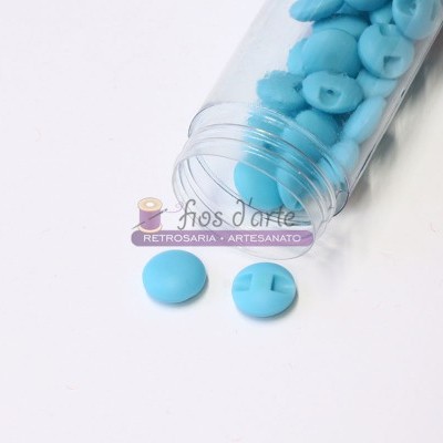 Frasco aberto com botões azuis redondos