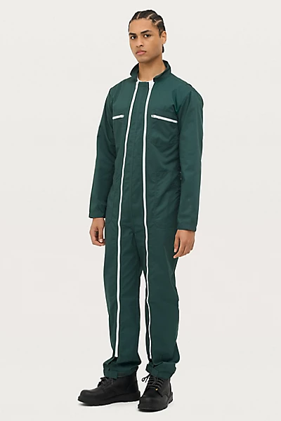 Macacão de trabalho verde escuro com fechos brancos e botins pretos