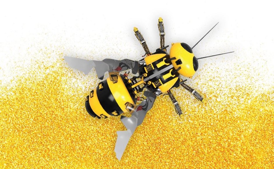 Robô amarelo e preto em forma de abelha sobre fundo branco com partículas amarelas.