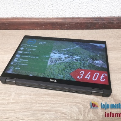 Computador portátil Dell Latitude 7390 2-in-1 preto em modo tablet na mesa