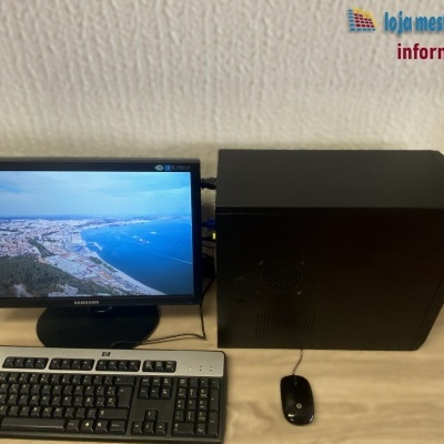Computador de secretária com monitor Samsung, teclado HP, rato HP e torre preta.