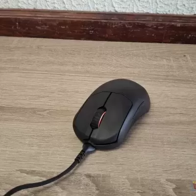 Rato de computador preto com fio sobre mesa de madeira clara