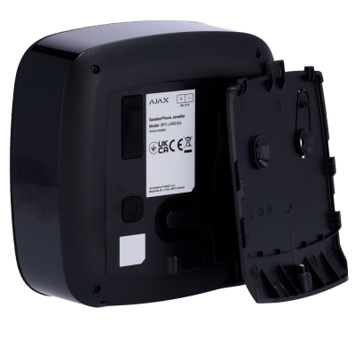 Aparelho preto com tampa aberta mostrando rótulo com texto e símbolos