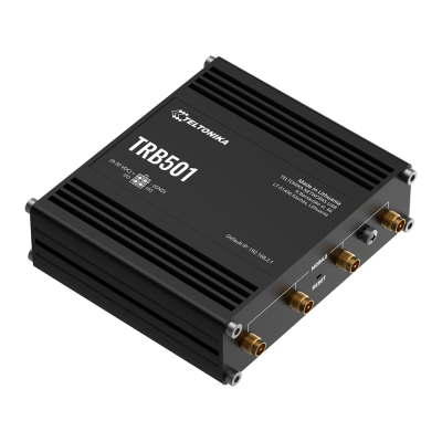 Dispositivo preto retangular Teltonika TRB501 com conectores dourados e texto branco.