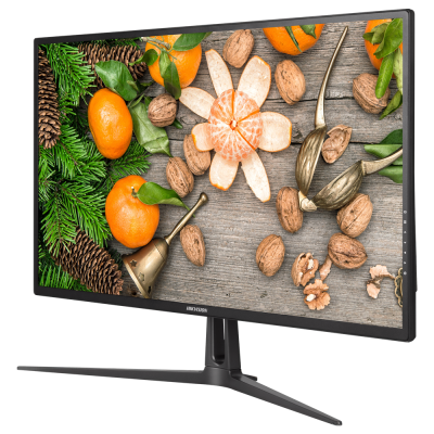 Monitor preto com imagem de tangerinas e nozes sobre madeira