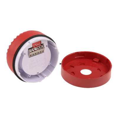 Dispositivo redondo vermelho com tampa removível e parte interior branca com ligações elétricas e interruptores vermelhos.