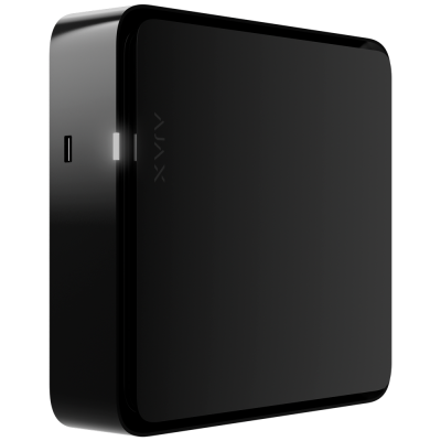 Aparelho eletrónico cúbico preto com luz branca e porta USB lateral