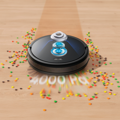Aspirador robô preto a limpar confeitos coloridos no chão de madeira