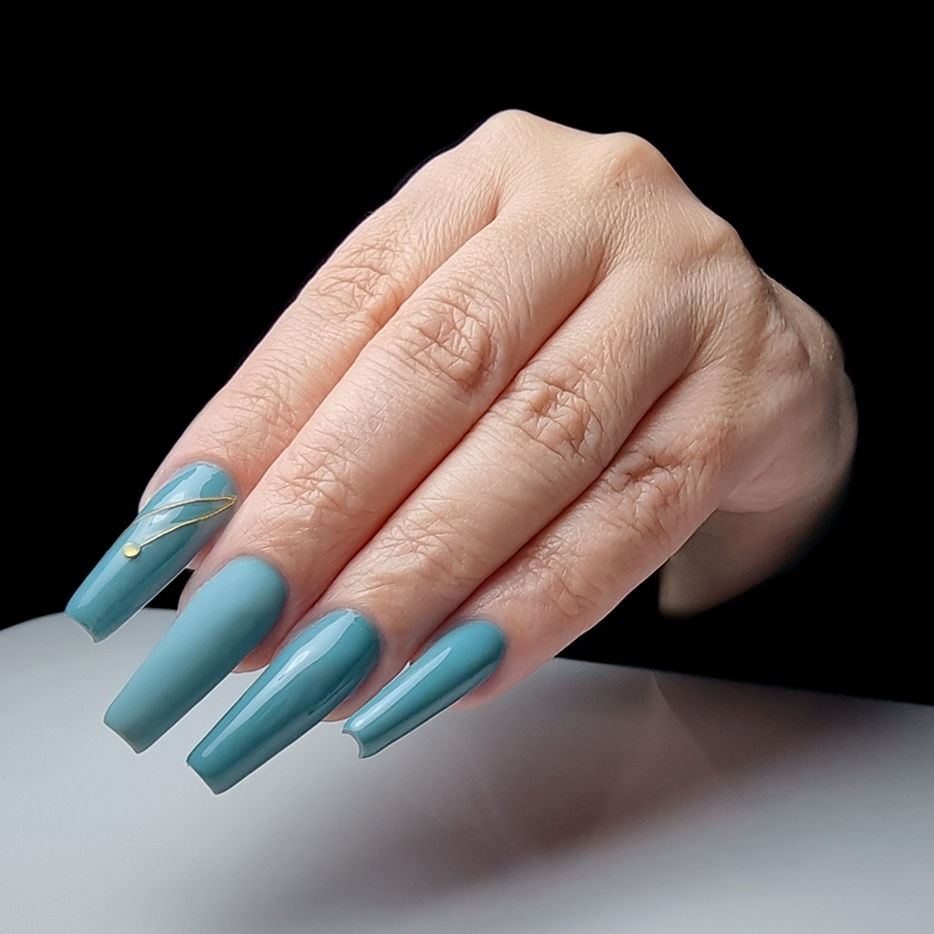 Unhas compridas azuis com detalhe dourado