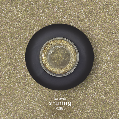 Frasco de glitter dourado com tampa preta sobre fundo dourado