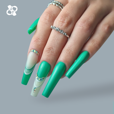Unha com verniz verde, branco e pedras brilhantes em mão com anéis prata