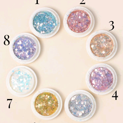 Oito frascos de glitter colorido numerados em círculo