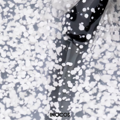 Frasco preto de verniz com partículas brancas e texto INOCOS