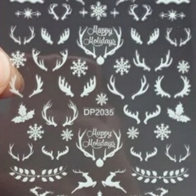 Folha de decalques brancos com temas natalícios sobre fundo preto