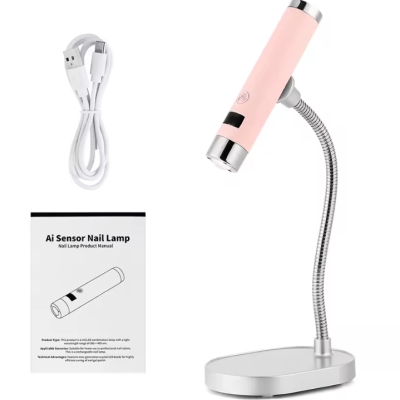Lâmpada para unhas rosa com base e pescoço metalizados, cabo USB e manual.