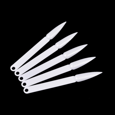 Cinco paletas de plásticos brancos para unhas com diferentes texturas em fundo preto