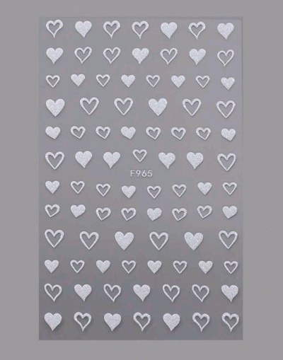 Autocolantes de unhas em forma de corações brancos variados sobre fundo cinzento