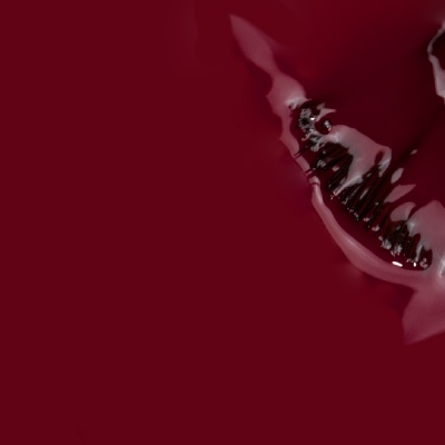 Varnish or nail polish of wine color with shiny and smooth texture.
